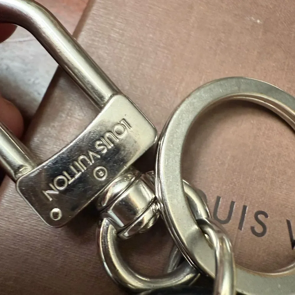 Used in great condition Louis Vuitton Silver and Black Keychain minor scratches